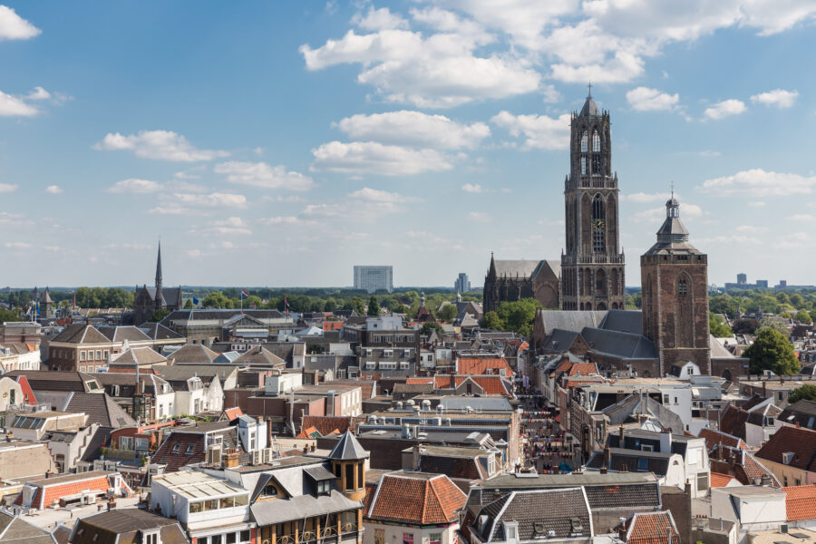 Aerial perspective of Utrecht, featuring the historic city layout and the iconic St. Martin's Cathedral
