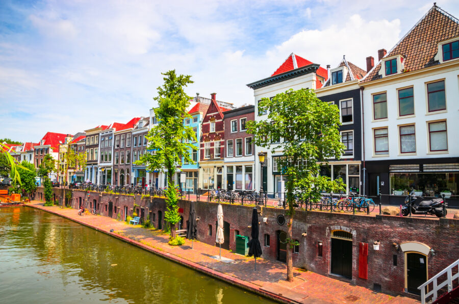 Row of traditional Dutch houses on the Oudegracht canal in Utrecht, Netherlands, highlighting the city's rich history