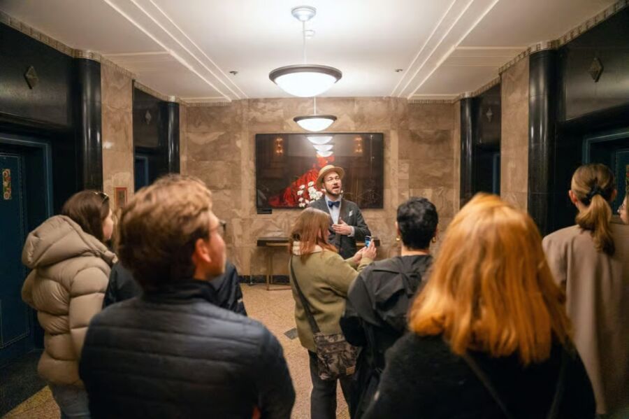 Group of people stands in a hallway during the Vancouver Hidden History Guided Walking Tour with Sweets Tasting.