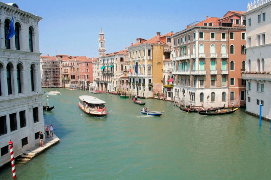 Venice canal with historic architecture, gondolas, and vibrant scenery.