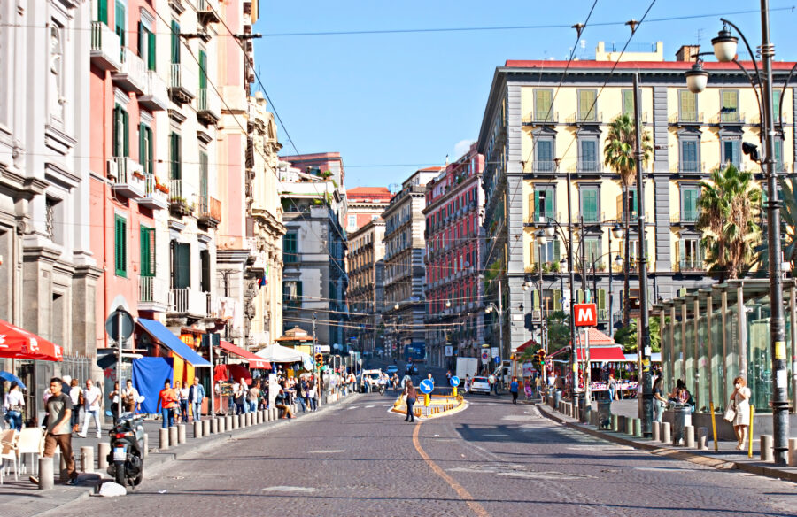 Busy street crowd and vibrant shops line Via Toledo in Naples, showcasing the lively atmosphere of the city