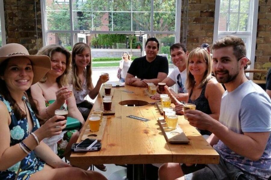 Guests seated at a table with beers, participating in the Victoria Craft Brewery and Distillery guided tour.
