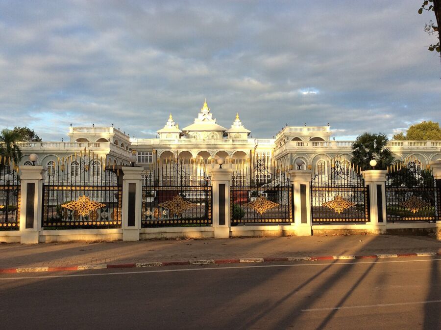 Spacious white structure featuring a grand gate, situated in Vientiane, Laos.