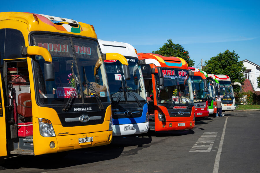 Colorful intercity sleeper buses lined up at Dalat Bus Station in Vietnam, ready for travelers to embark on their journeys.