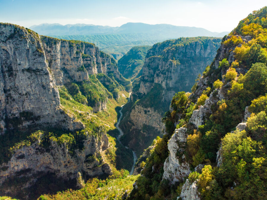 Aerial view of Vikos Gorge, a deep gorge in the Pindus Mountains of Greece, located on the southern slopes of Mount Tymfi.
