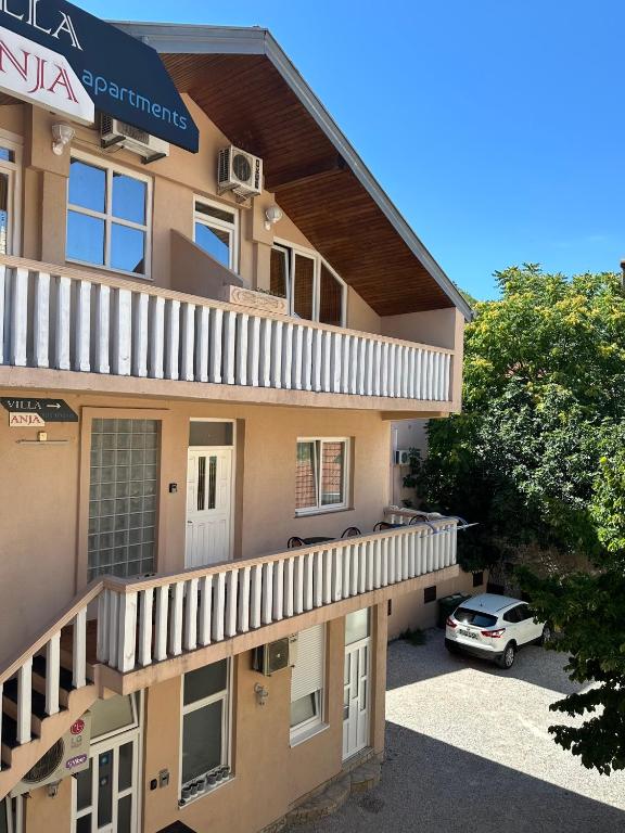 Exterior view of Villa Anja Apartments in Mostar, featuring a contemporary design and inviting entrance.
