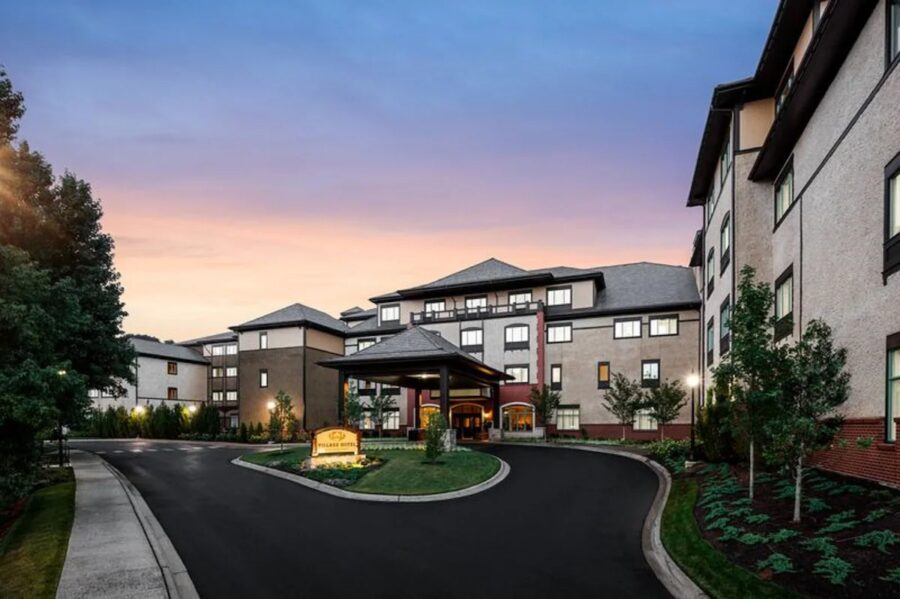 The Village Hotel on Biltmore Estate, featuring charming design and surrounded by beautiful landscapes and gardens.
