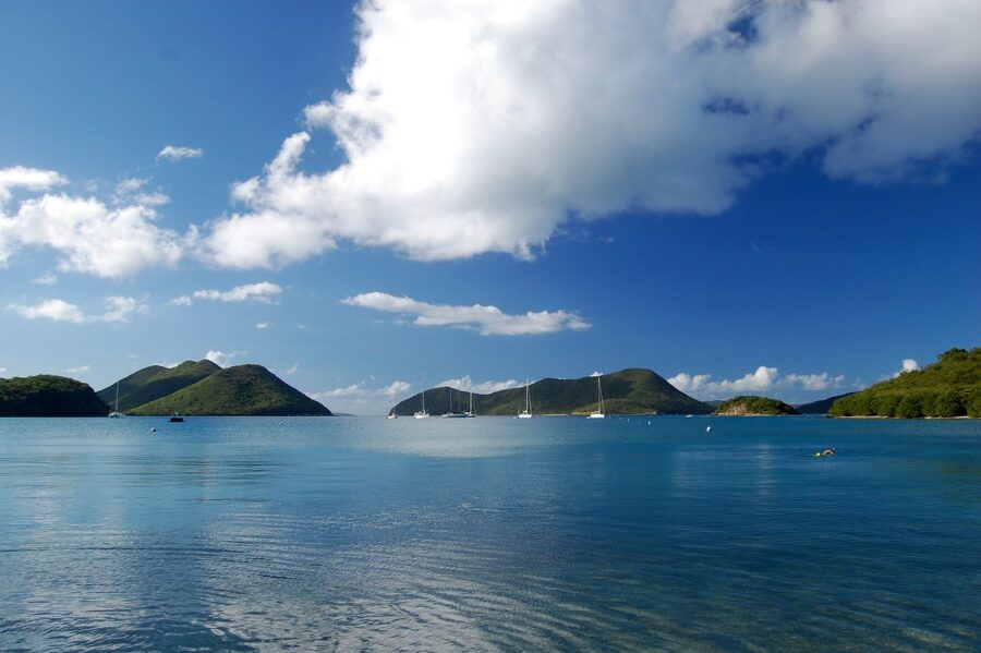 Tranquil blue waters dotted with boats, showcasing the beauty of Virgin Islands National Park, St. John.
