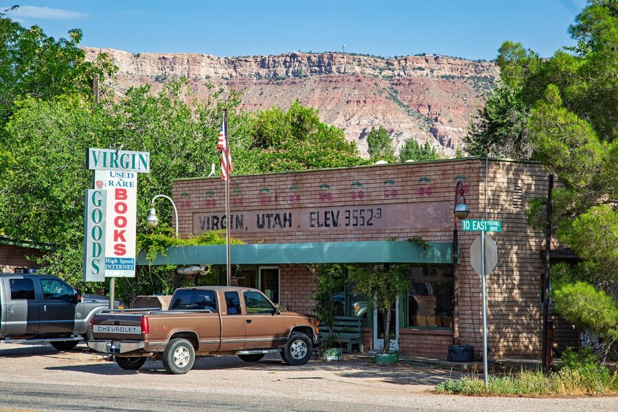 In Virgin, Utah, a truck is parked in front of a store, framed by a mountain in the background.

