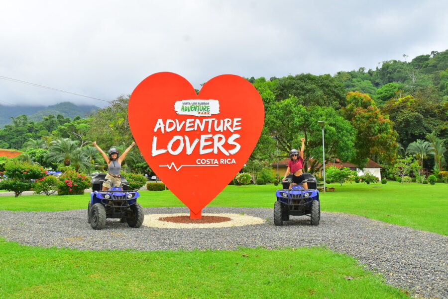 Adventurers riding ATVs through lush landscapes at Vista Los Sueños Adventure Park, surrounded by tropical scenery.
