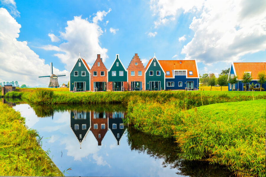 Colorful houses line the marine park in Volendam, a picturesque town in North Holland, Netherlands.