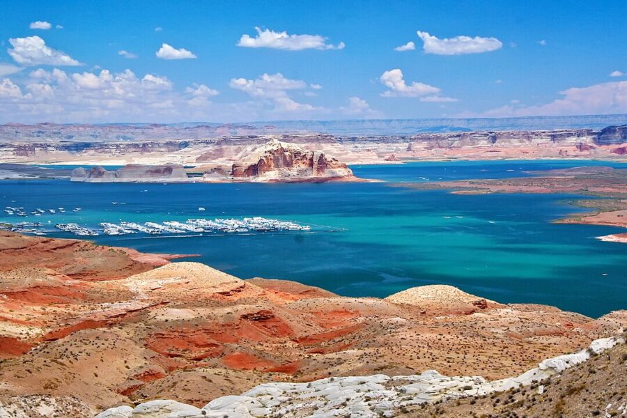 Scenic view of Wahweap Marina at Lake Powell, Arizona, showcasing the vibrant blue water and surrounding red rock formations.
