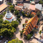 Aerial view of Wat Ket Karam Temple in Chiang Mai, Thailand, highlighting its traditional architecture amidst lush greenery