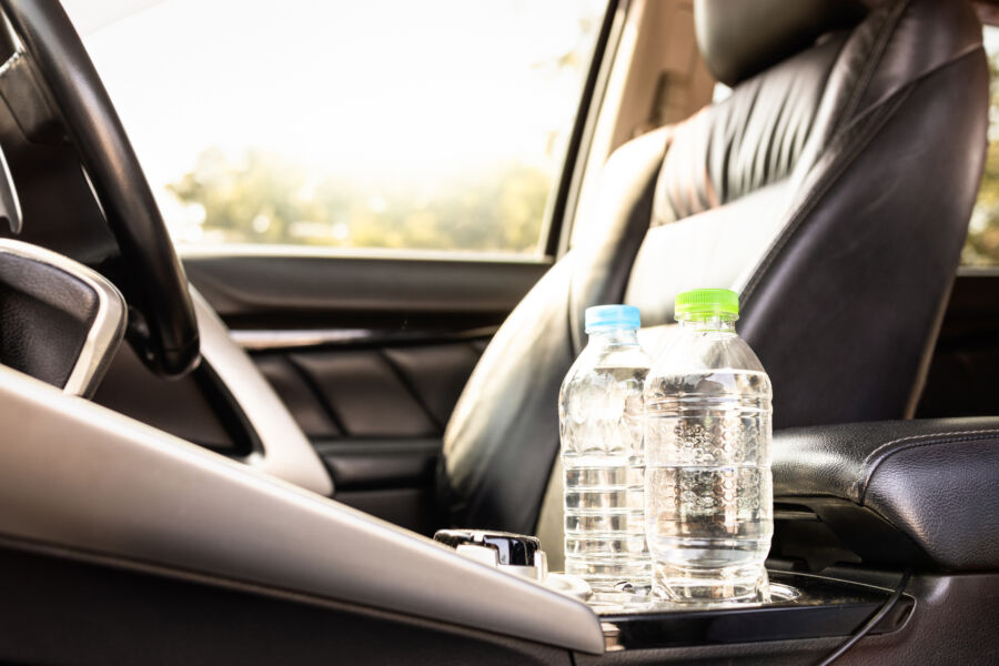 Plastic water bottles arranged on a car seat, ready for hydration during travel