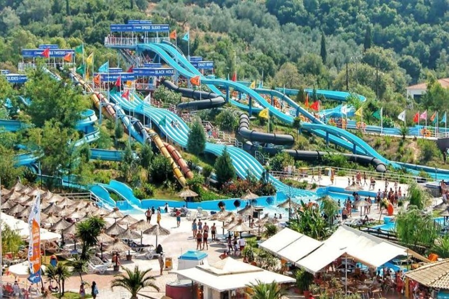 Vibrant water park with thrilling slides, lush backdrop, and lively summer activities.