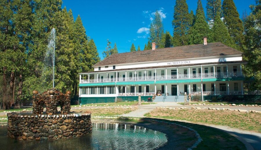 Wawona Hotel, a large white house with a fountain, set in the scenic landscape of Yosemite National Park.