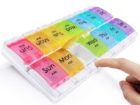 Two-row weekly AM/PM pill organizer, 14 compartments with colored lids for medication.
