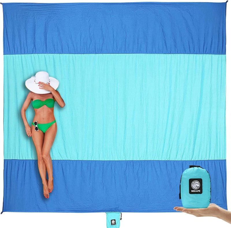 Woman in a bikini rests on a WEKAPO sandproof beach blanket, enjoying the sun on the beach.