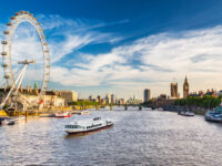 The iconic Westminster Parliament building alongside the River Thames, showcasing its Gothic architecture and scenic surroundings.