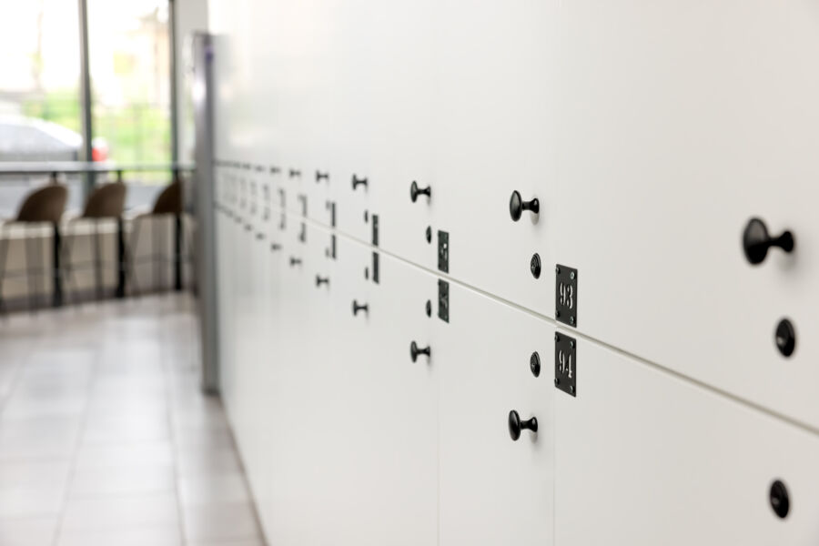 Modern hostel featuring rows of white lockers, designed for convenient and secure storage for travelers