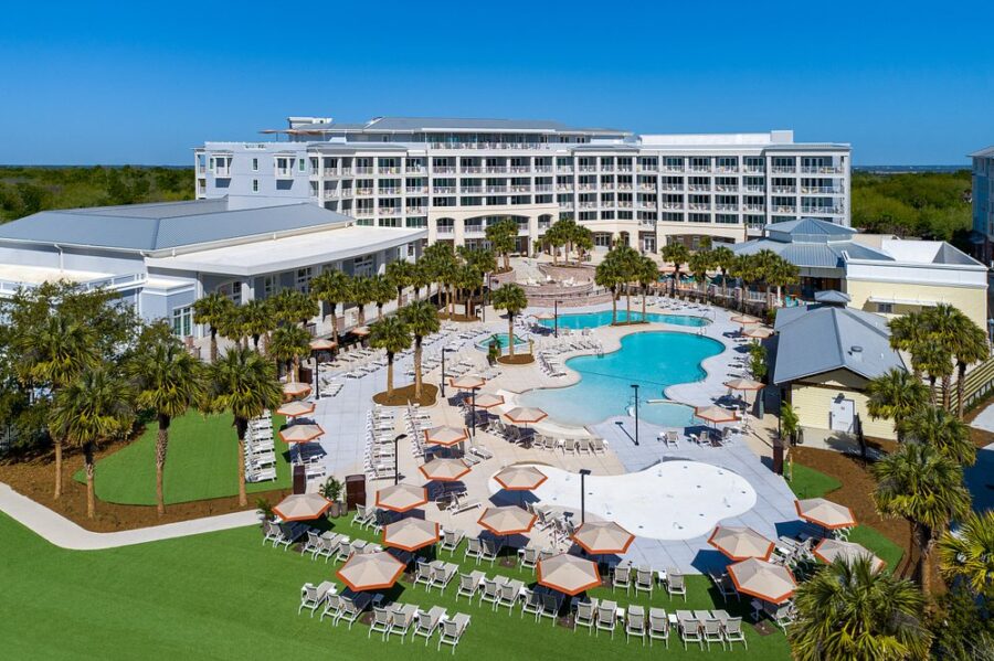 Wild Dunes Resort in Charleston features a beachside pool and lawn chairs for relaxation by the ocean.