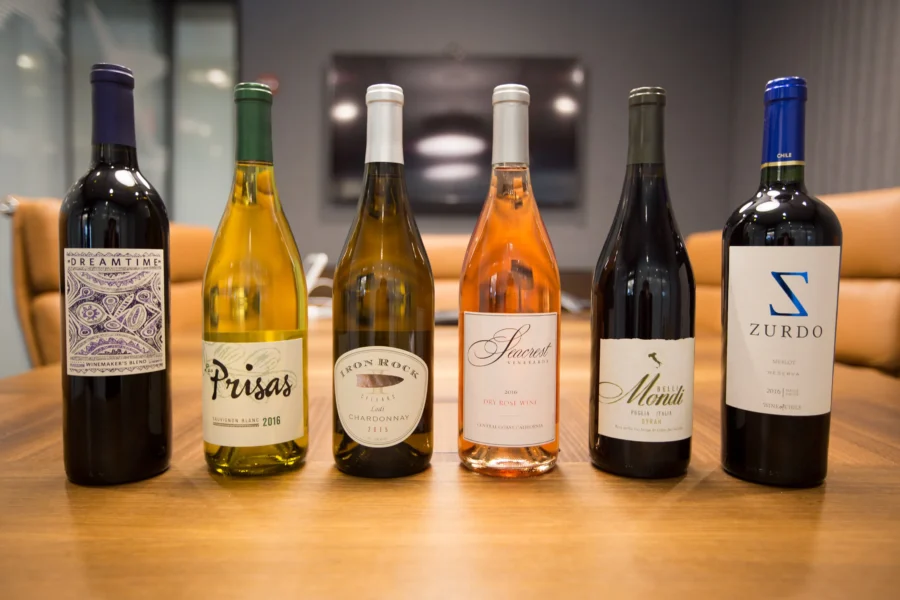 Wine bottles display in modern setting showcasing diverse vintages and varietals.