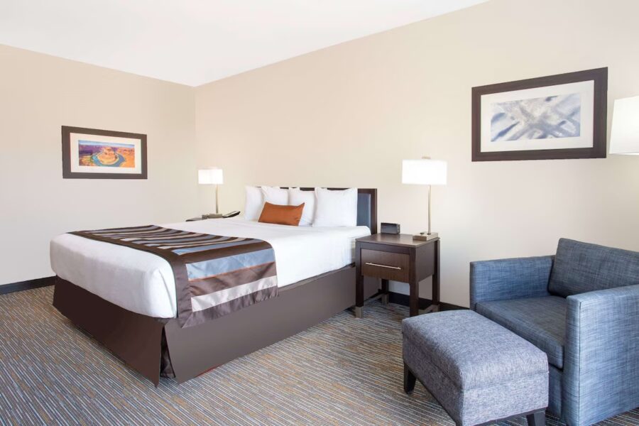 Hotel room at Wingate by Wyndham Page Lake Powell featuring a bed, chair, and desk.
