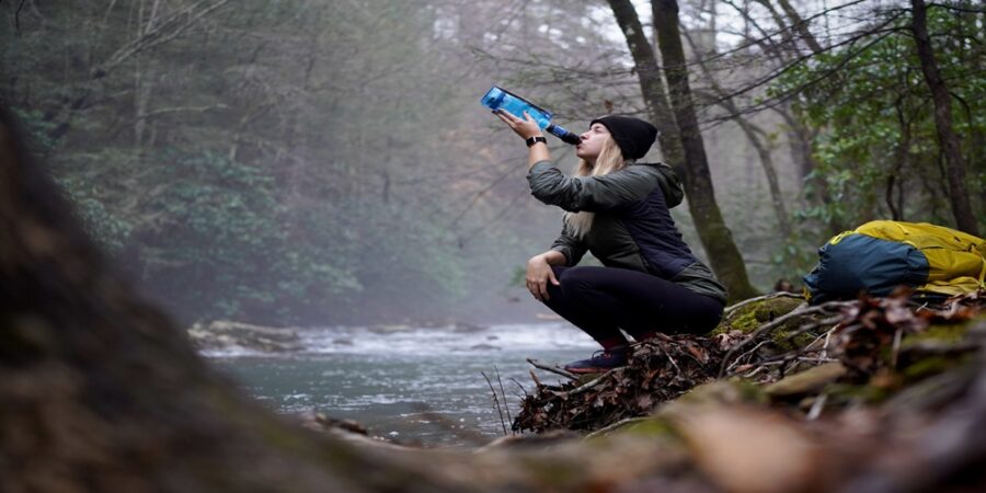 woman nature hike stream