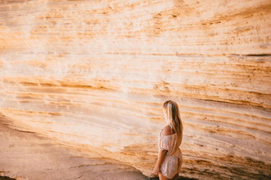 woman rock wall contemplation