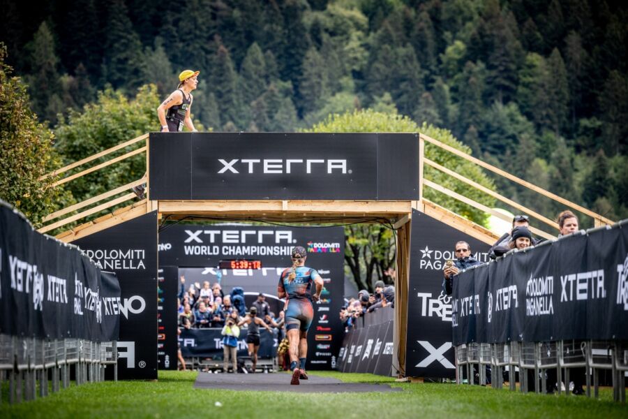 XTERRA World Championship triathlon in Dolomites: athletes compete amidst stunning mountain backdrop.