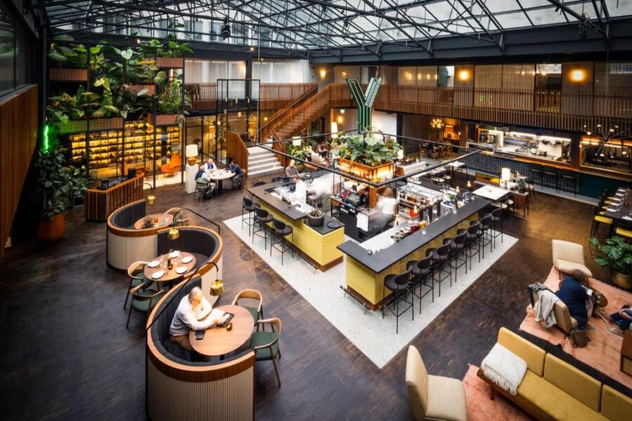 The Yalo Urban Boutique Hotel bar features modern decor with stylish seating and a variety of drinks displayed on shelves.