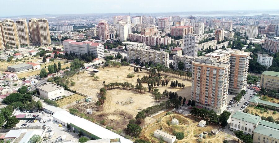 Aerial view of Yasamal District in Baku, showcasing a mix of buildings and greenery among the urban landscape.