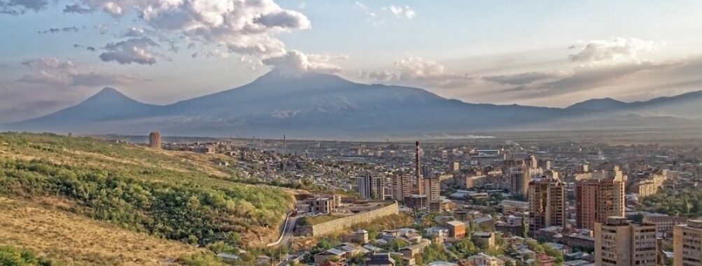Aerial view of Yerevan, Armenia, showcasing the city's layout and surrounding landscape.