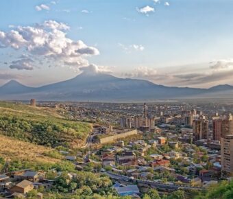 Aerial view of Yerevan, Armenia, showcasing the city's layout and surrounding landscape.
