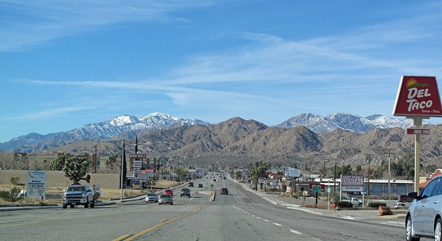 Scenic view of mountains from a desert street in Yucca Valley, California, showcasing the arid landscape and distant peaks.