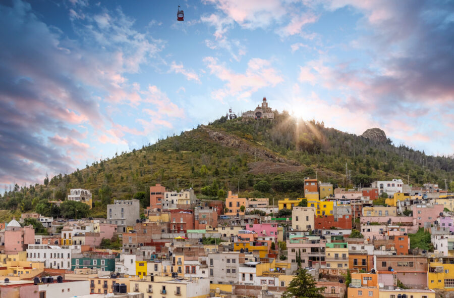Aerial view of Zacatecas City skyline, showcasing urban architecture and landscape under clear daytime skies
