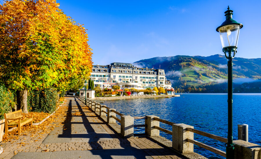 Scenic view of Zell am See, Austria, featuring a serene lake surrounded by mountains and lush greenery