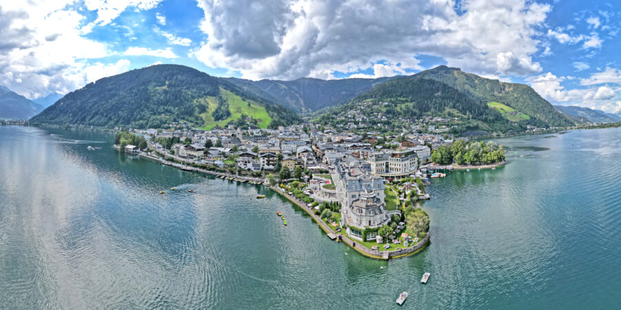 Panoramic view of Zell am See, Austria, showcasing the lake, mountains, and charming town nestled in the valley