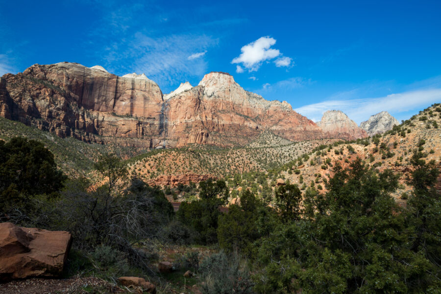Bright sunny day highlighting a majestic mountain range in Zion National Park, Utah, surrounded by vibrant greenery