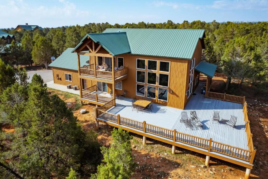 Cabin with a deck at Zion Ponderosa Ranch Resort, surrounded by trees and scenic views of the landscape.