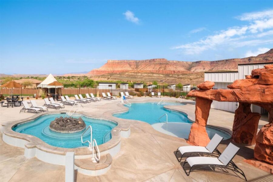 The inviting pool and hot tub at Zion Wildflower Resort, Utah, offering a relaxing retreat amidst beautiful scenery.
