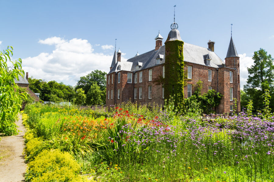 Lush gardens of Zuylen Castle in Oud-Zuilen, showcasing vibrant flowers and manicured lawns near Utrecht.